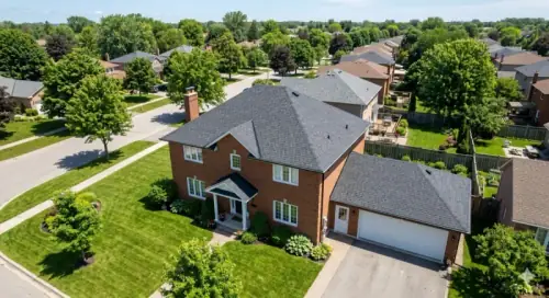 Aerial view of a home with a new charcoal asphalt shingle roof in Thunder Bay
